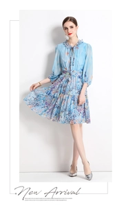Detail of light blue floral chiffon dress with puff sleeves and ruffled drawstring neckline