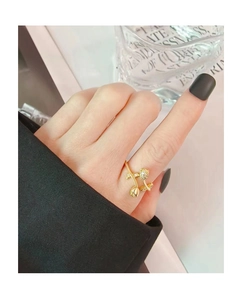 Detailed close-up of a gold tulip ring set with sparkling zircons on a model's finger