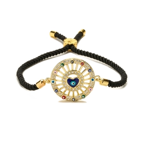 Adjustable black braided rope bracelet with golden heart-shaped evil eye charm and zircons
