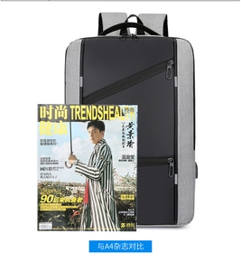 Business laptop backpack in grey and black shown next to an A4 magazine for size comparison