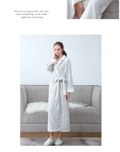 Detailed close-up of thick coral fleece fabric on a long grey belted women's bathrobe