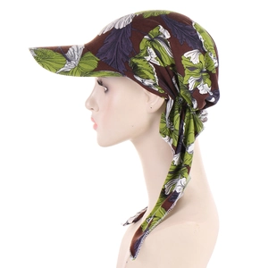 Detail view of the soft brown floral headwrap with green patterns on a mannequin
