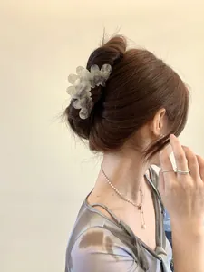 Detail showing marble texture purple acetate cloud hair claw clip on model's hair
