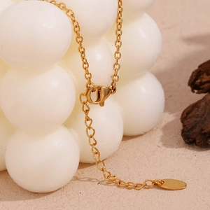 Detail of 18K gold plated necklace showing lobster clasp and K18 hallmark tag