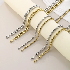 Detail of gold and silver plated necklaces in flat, bead, and twist chain styles