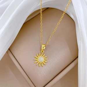 Elegant gold spinning sunflower pendant necklace with white crystals on silk