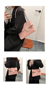 Detail view of pink pleated handbag with metal buckle and chain strap shown on model