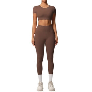 Deep brown two-piece yoga set featuring a cropped short sleeve top and high-waisted leggings