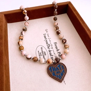 Vintage bohemian beaded necklace with brown heart pendant and natural stone textures
