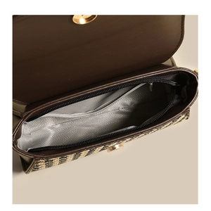 Top view of the handbag interior with herringbone lining, zipper pocket, and magnetic snap