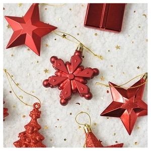 Detail view of assorted red Christmas ornaments with matte and glitter finishes