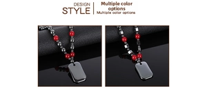Detail view of hematite beaded necklace with red accents and metallic dog tag pendant