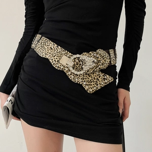 Close-up of leopard print leather belt featuring a large rhinestone butterfly buckle