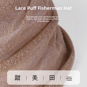 Detail of breathable lace fabric with pleated design on a chic brown summer bucket hat