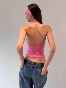 Detailed back view of a pink halter neck backless crop top with slim fit silhouette