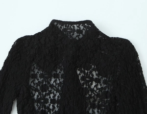 Close-up of high neck black lace long sleeve bodysuit showing intricate hollow-out texture