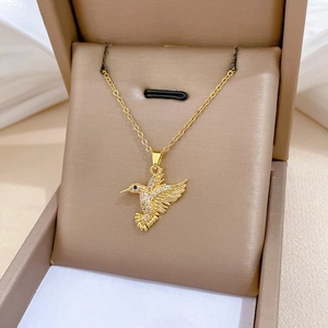 Macro shot of gold hummingbird necklace with sparkling pavé cubic zirconia details
