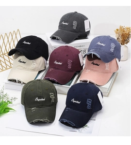 Detail of vintage washed cotton baseball caps with Capital embroidery and distressed holes