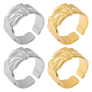 Detailed view of gold and silver stainless steel rings with geometric quilted texture