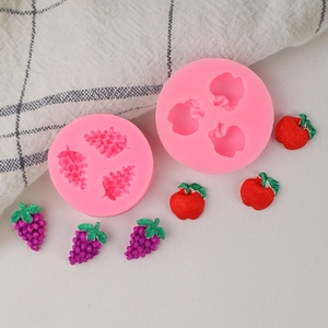 Detail of pink silicone molds for grapes and apples shapes for DIY fondant and crafts