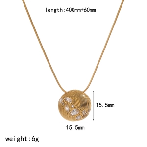 Detailed view of gold 18k necklace with zircon studded textured sphere pendant and specs