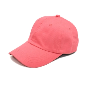 Side view of a coral pink cotton baseball cap with breathable eyelets and curved brim