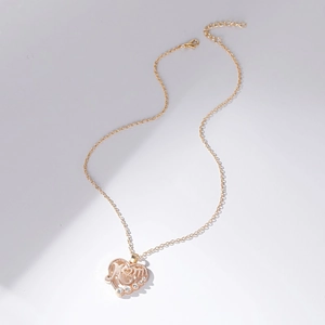 Detailed view of gold MOM heart pendant with sparkling cubic zirconia and adjustable chain