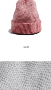 Detailed knit texture and ribbed design of a red and grey winter beanie hat