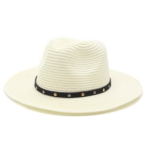 Detail of cream straw fedora hat featuring black ribbon and metal rivet studs