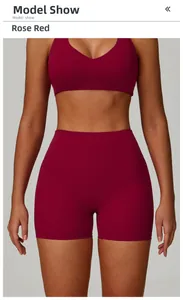 Close-up of rose red high-waisted yoga shorts and V-neck sports bra on model