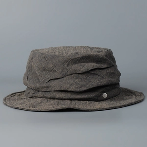 Detailed view of the high-end distressed linen fabric texture on a fashion bucket hat