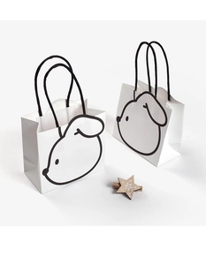 Close-up of minimalist white gift bags with black rabbit illustration and braided rope