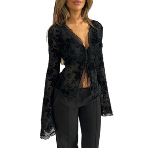 Detail of black chiffon blouse with burn-out floral texture, V-neck, and flared sleeves