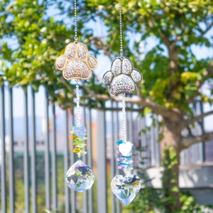 Detail of gold and silver paw suncatchers with crystal prisms and heart charms