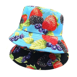 Reversible bucket hats in black and light blue featuring vibrant berry fruit prints