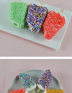 Detailed view of colorful faux ice cream popsicles on display trays for home decor
