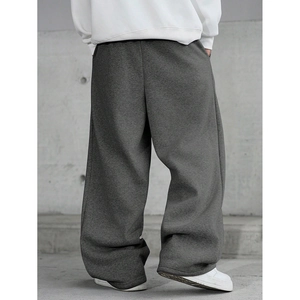 Back view of loose fit dark grey joggers showing heavy knit texture and draped silhouette