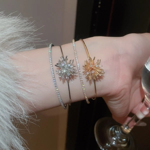 Stacked zircon fireworks bracelets in gold and silver finish with starburst details