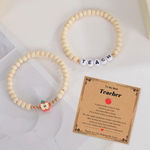 Detail of wooden bead teacher bracelets with apple charm and a thank you gift card