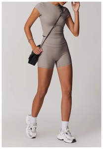 Detail of grey athletic crop top and high-waisted shorts set with smooth matte texture