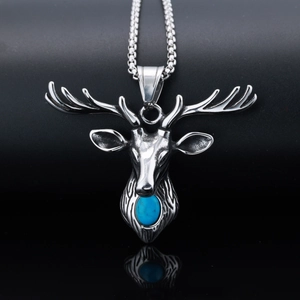 Detailed close-up of silver deer head pendant necklace with blue stone on dark background