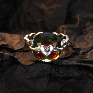 Close-up of heart-shaped silver ring with square rainbow gradient cubic zirconia
