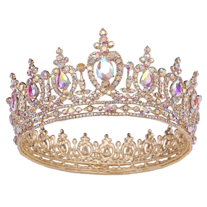 Detailed macro view of golden baroque crown with teardrop crystals and cross ornament