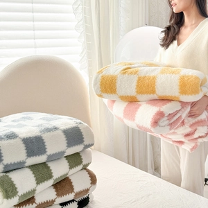 Checkerboard pattern plush fleece blanket available in multiple colors for home or office