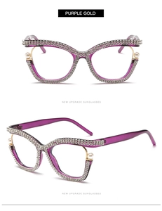 Detail of purple cat eye glasses frame with inlaid rhinestones and pearl accents