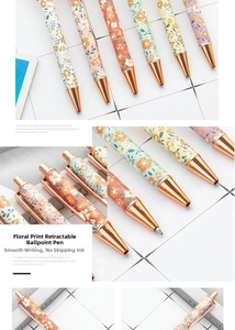 Macro shot of floral click ballpoint pens with rose gold metal clips and tips