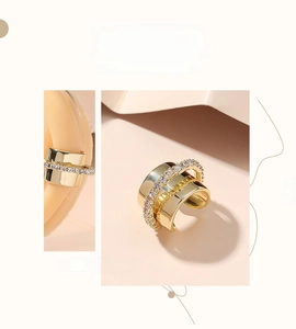 Detailed view of multilayer gold ear cuff with shimmering micro-pave crystals