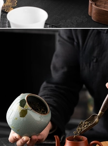 Close-up of ceramic tea canister with ice-crackle glaze and floral design for loose tea