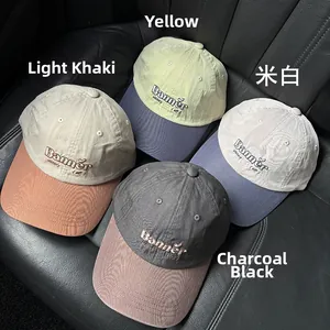 Detailed view of color-block cotton baseball caps with embroidered Banner Victory text
