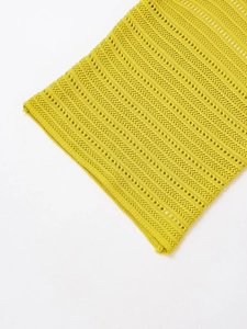 Detailed close-up of bright yellow halter knitwear with hollow texture and refined weave